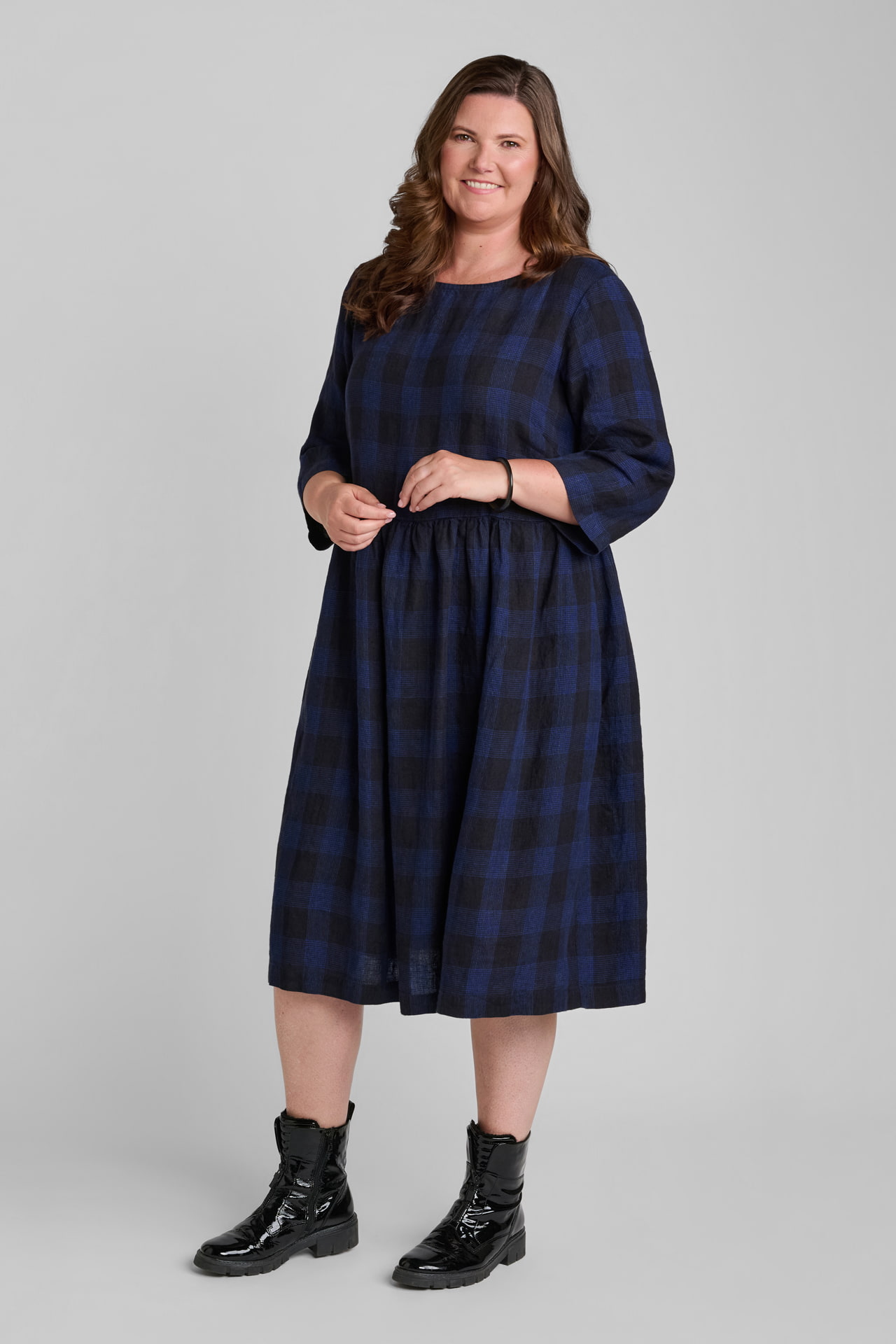 Woman in blue and black plaid linen dress