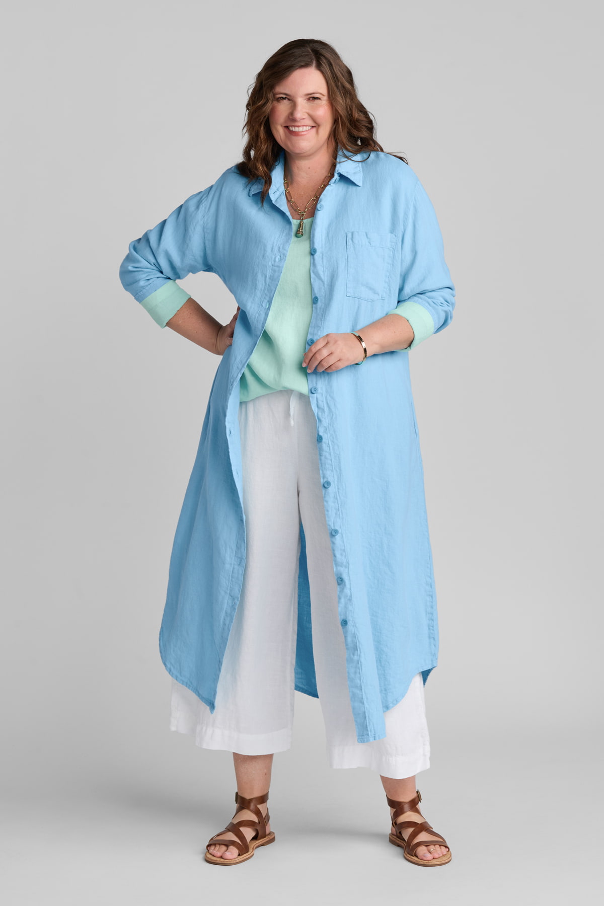 Woman in blue linen shirtdress with white linen pants
